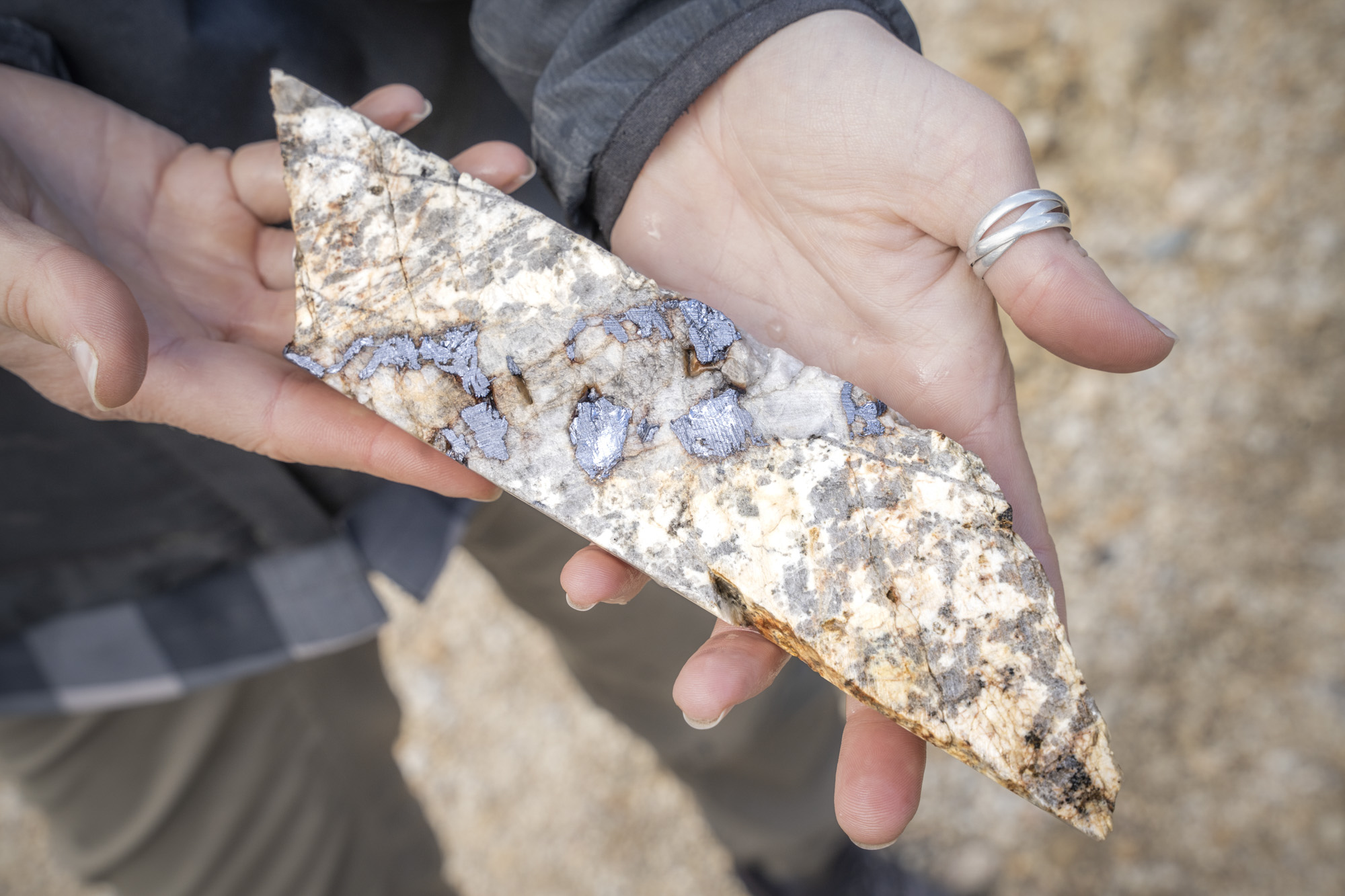 Close-up mineral sample core in hand